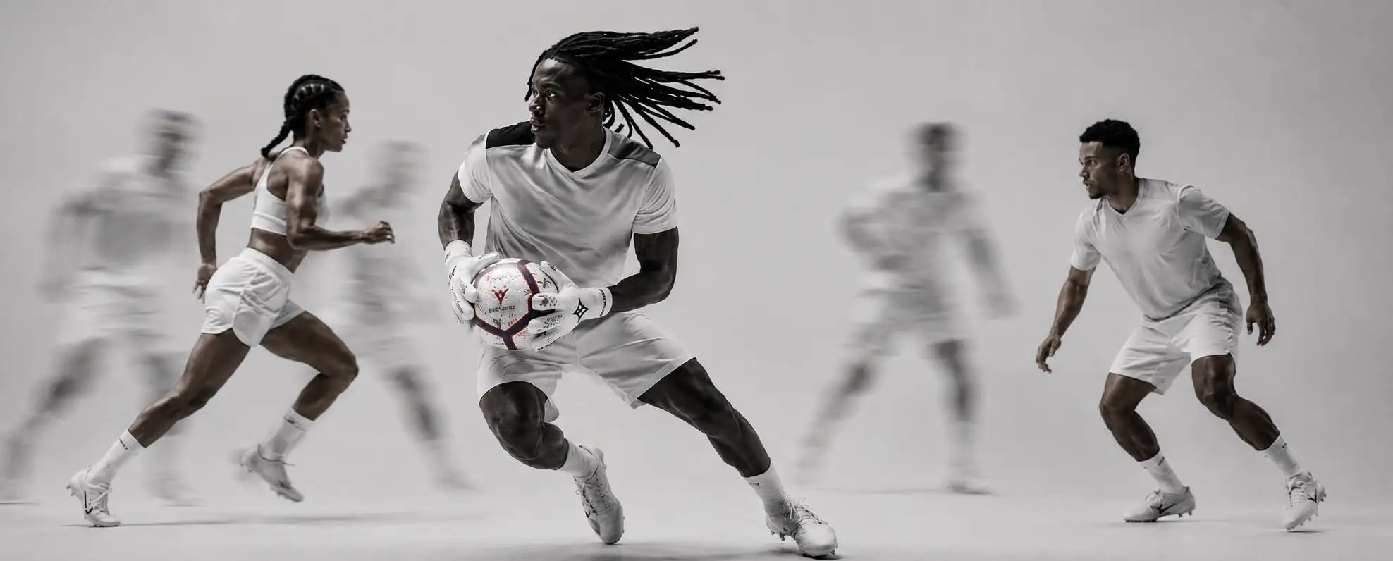 Black person holding football three people in background with blury effect