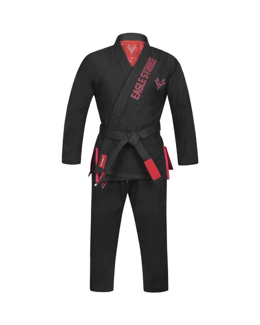 A black Brazilian Jiu-Jitsu gi with red accents, featuring a red inner collar lining, red 'EAGLE STRIKES' branding on the chest, and red-and-black belt tabs, displayed on a solid white background.
